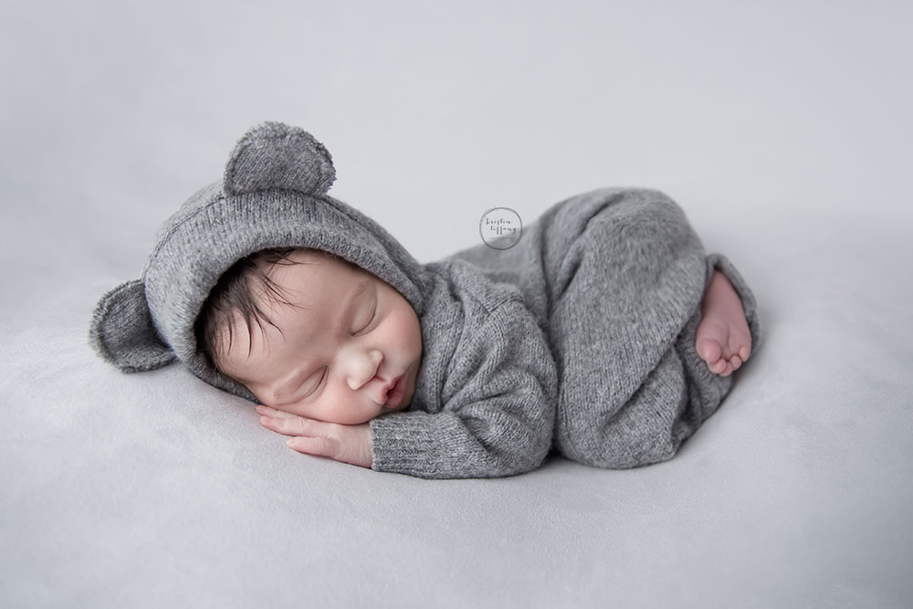a photo of a baby boy wearing a cute bear outfit