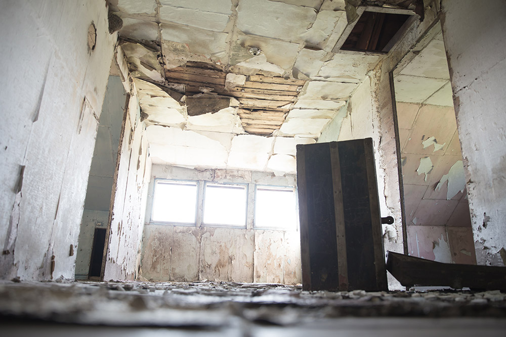 a photo of the upstairs in an abandoned home