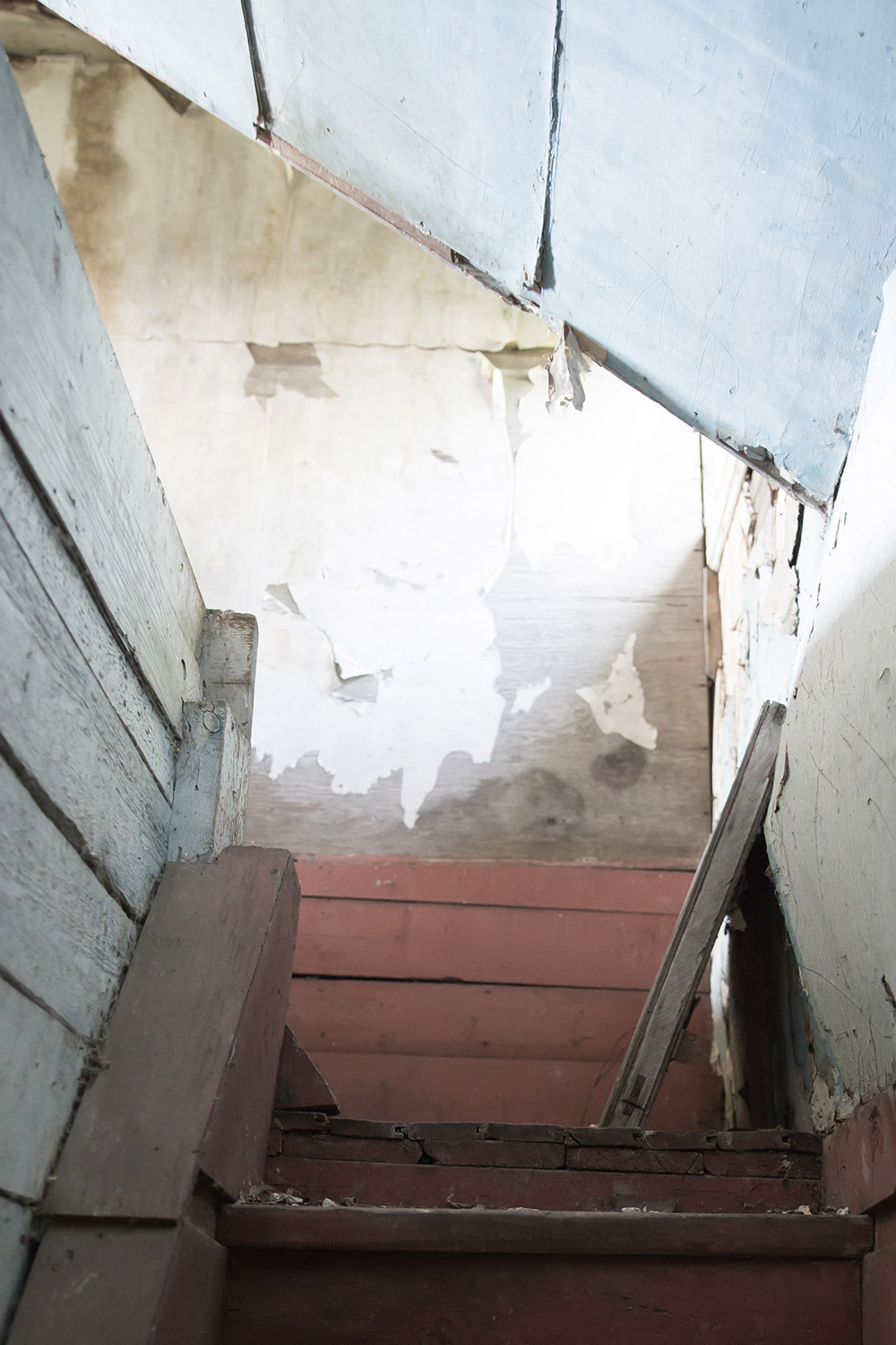 a photo of an old stairwell in an abandoned home