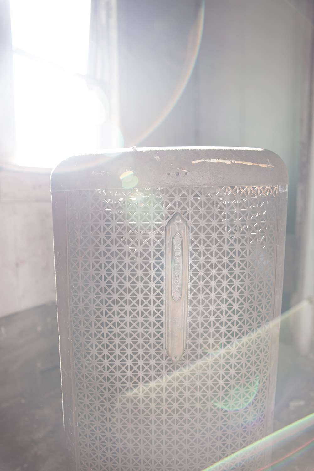 a photo of an old appliance in an abandoned home