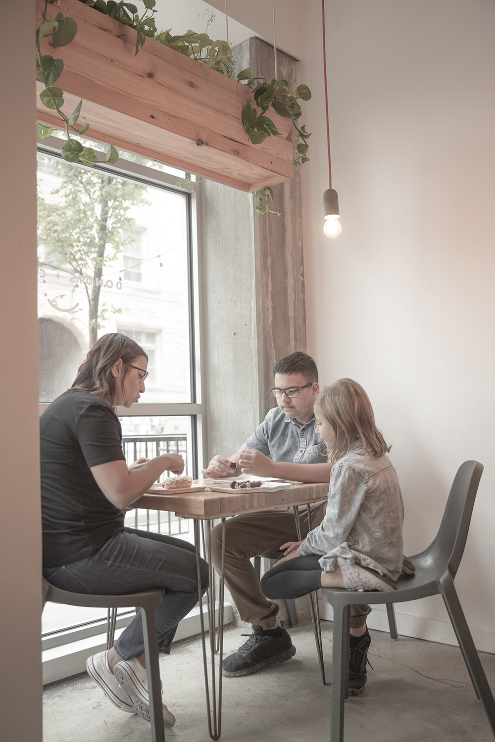 a photo of a family having doughnuts in a doughnut shop
