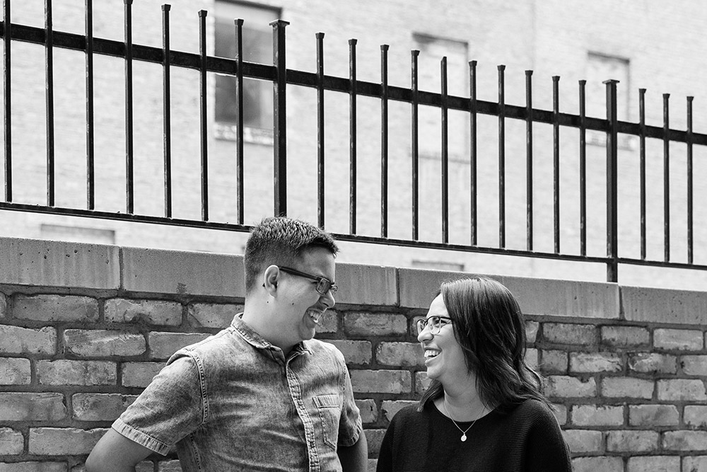 a black and white photo of a mother and son smiling at eachother