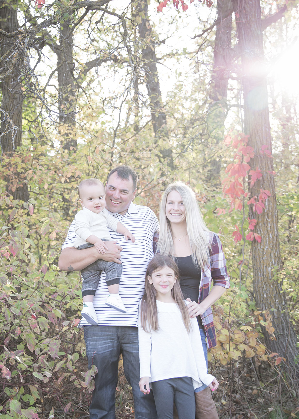 a photo of a young family in the fall time