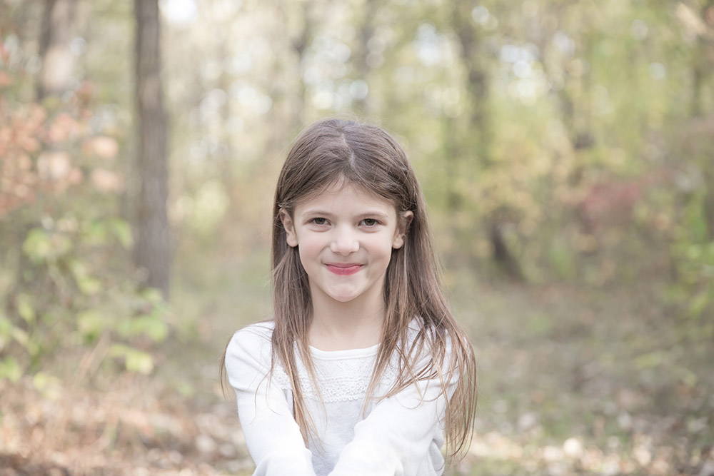 a photo of a young girl outside in fall