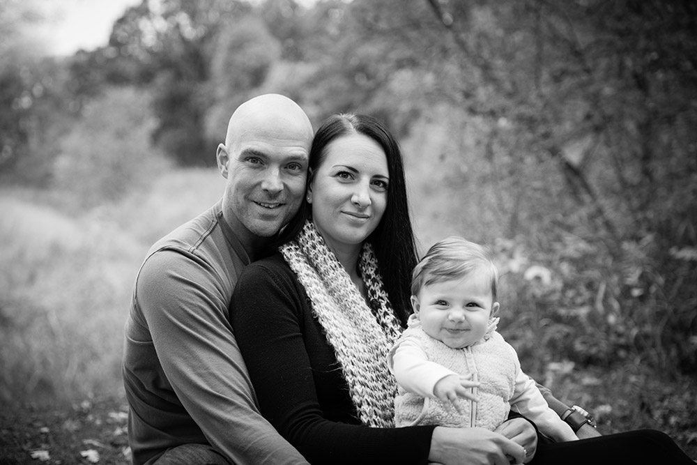 a black and white photo of a young family