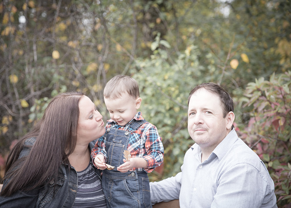 a photo of a family outside in the fall