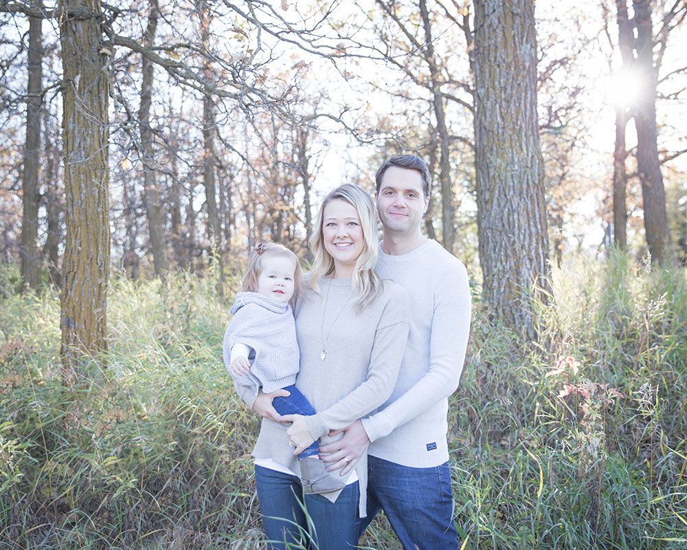 a photo of a young family in the fall time