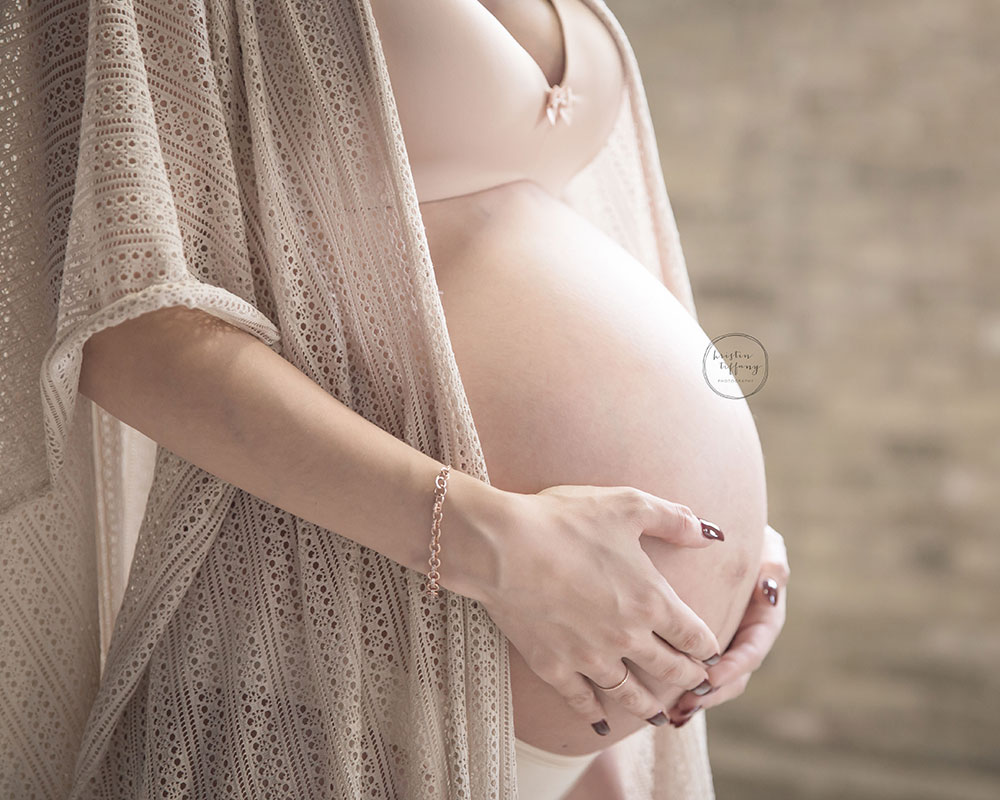 a maternity photo with a close up of her baby bump