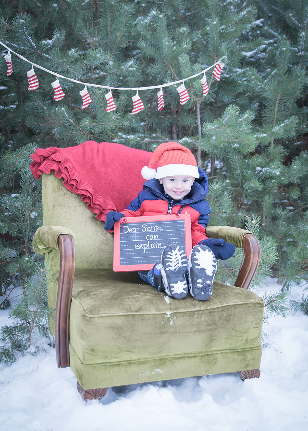 a photo of a young boy holding a sign for santa
