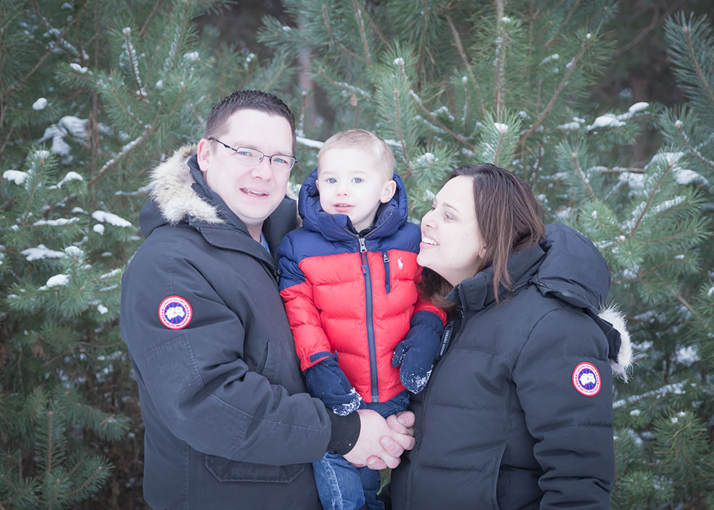 a photo of a young family outside in the winter in their winter coats
