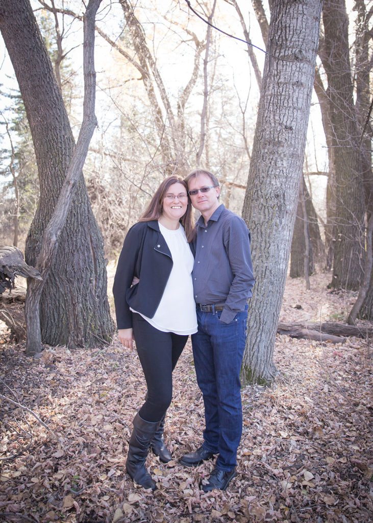 a photo of a couple in the woods in the fall