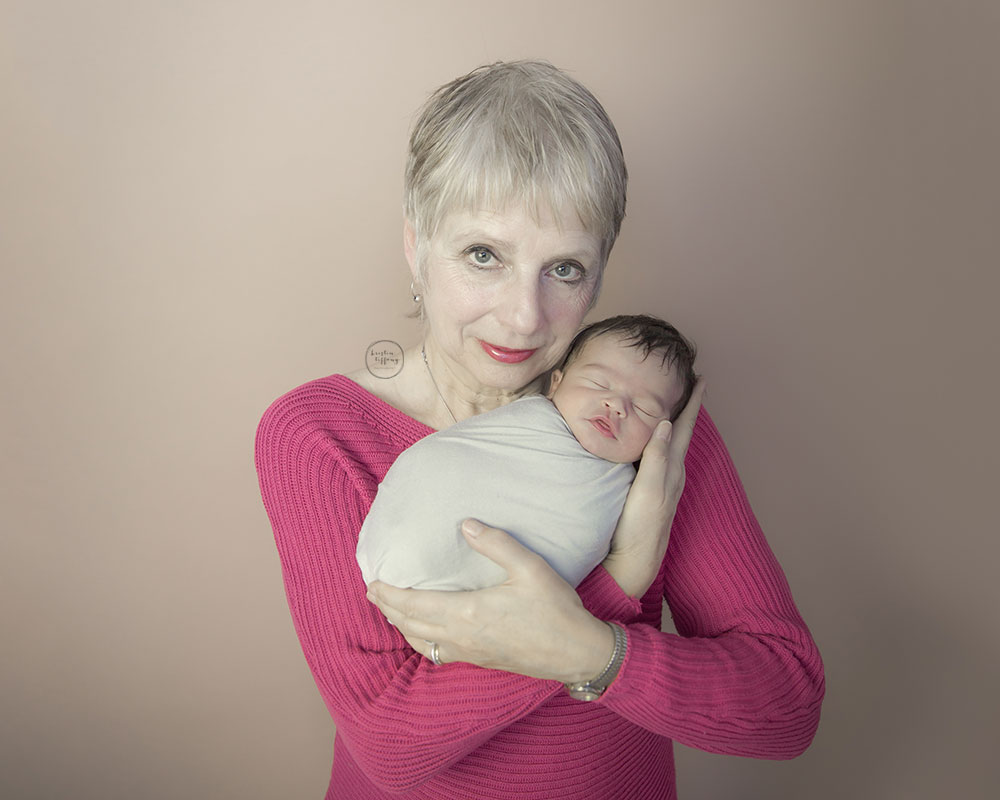 a photo of a newborn baby boy and his grandma