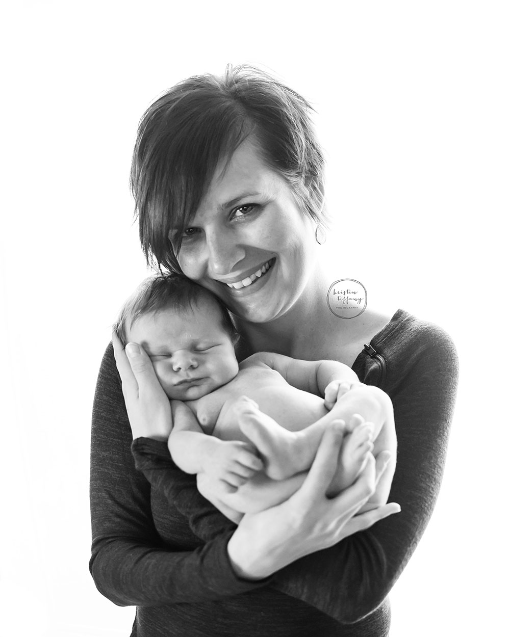 a black and white photo of a mother and her newborn baby boy