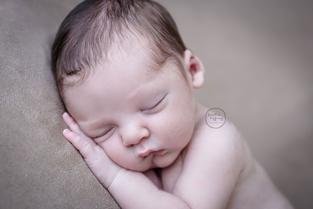 a photo of a newborn baby boy sleeping