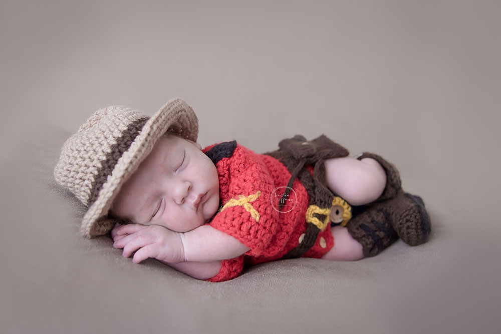 a photo of a newborn baby boy in an rcmp outfit