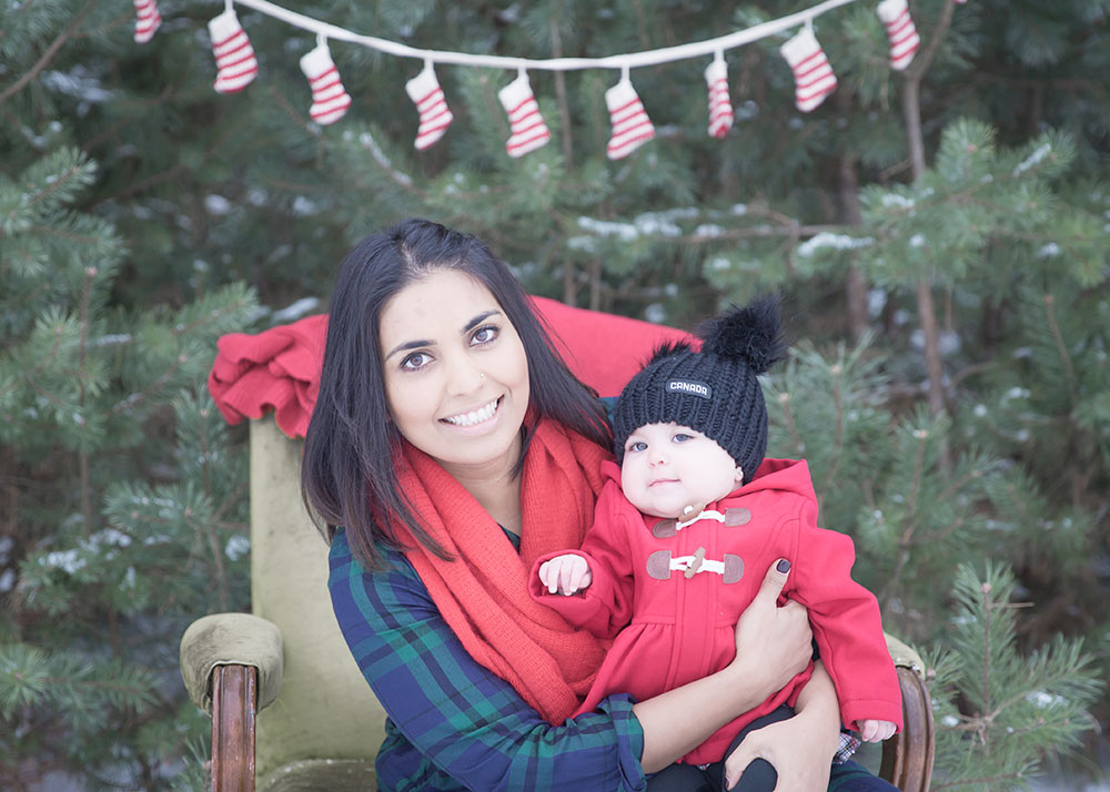 a photo of a young mother with her daughter outside in winter on an old chair