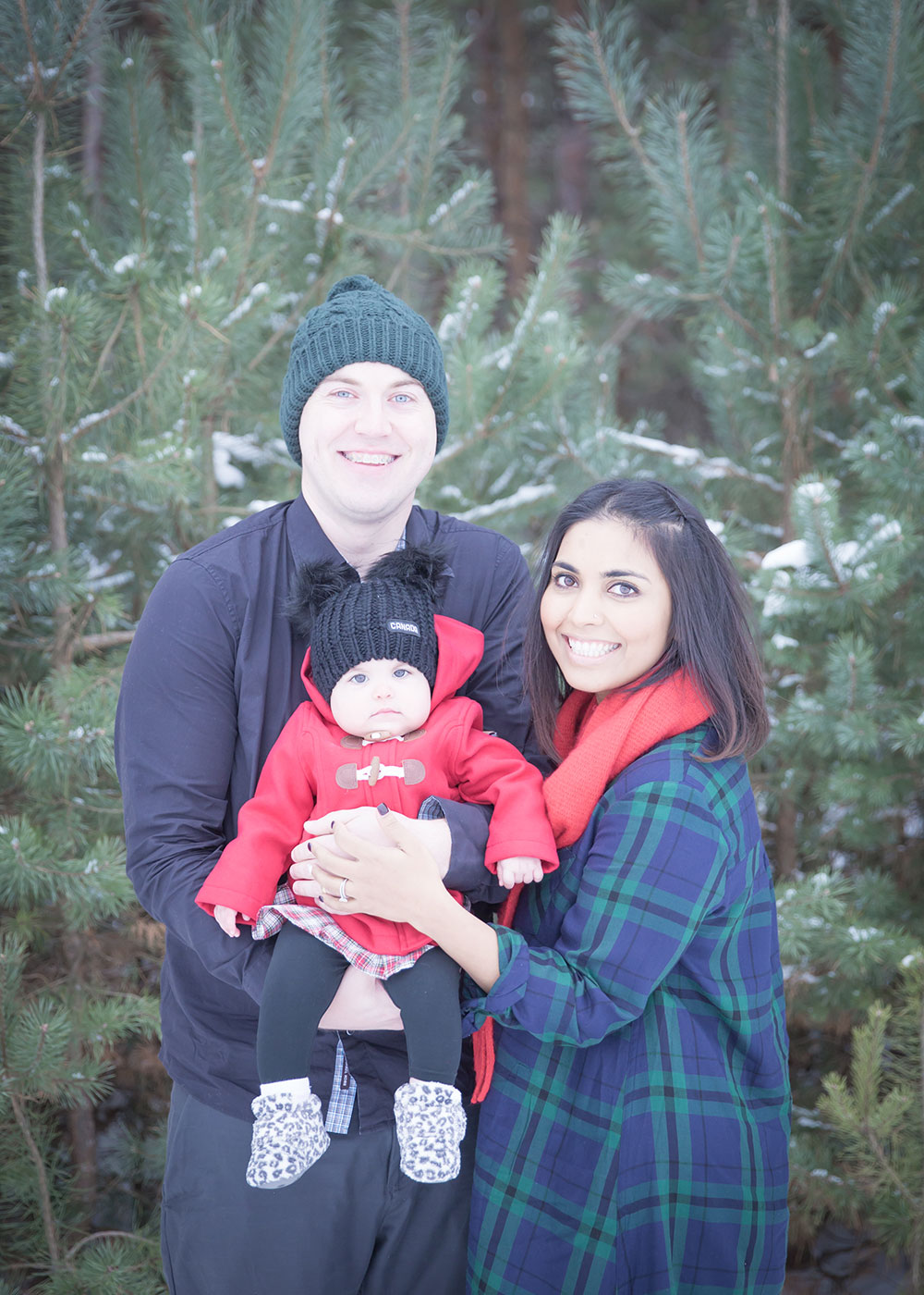 a photo of a young family outside in winter