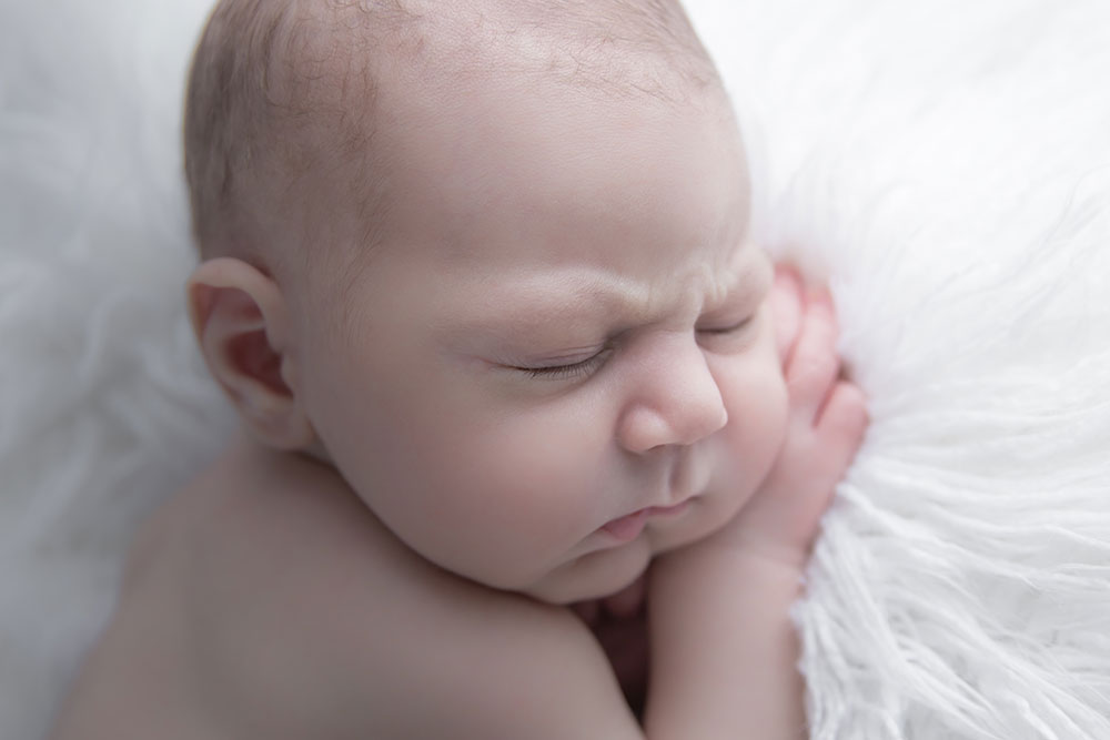 a close-up photo of a sleeping baby boy