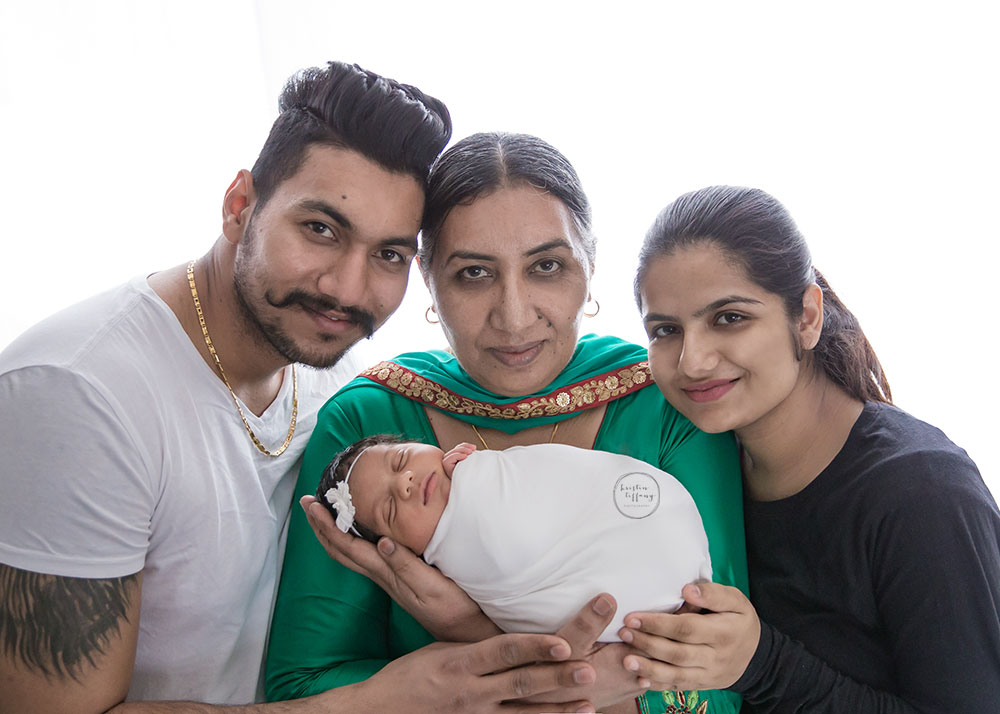 a family photo with a newborn baby girl