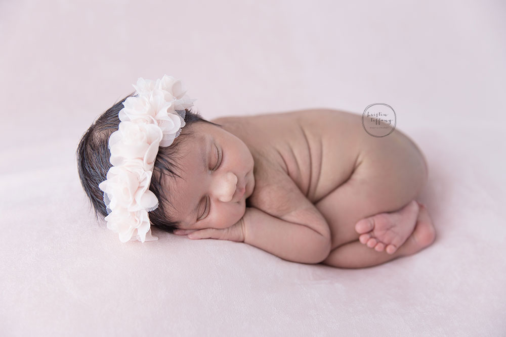 a photo of a posed newborn baby girl