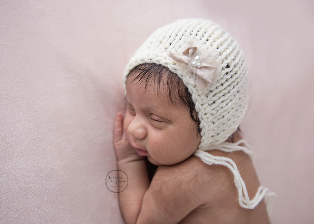 a photo of a posed newborn baby girl