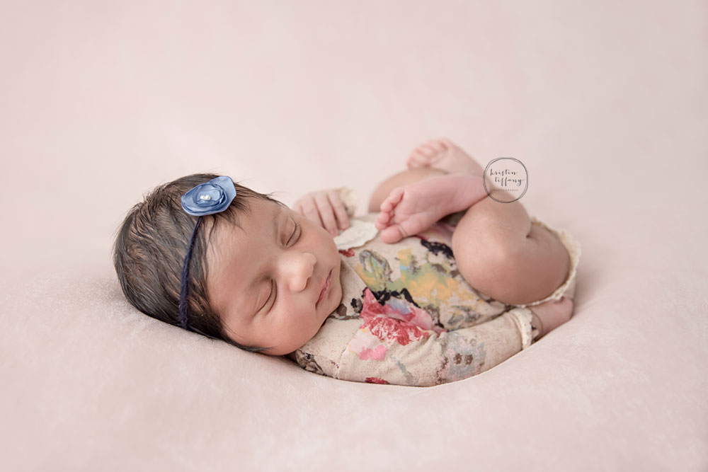 a photo of a posed newborn baby girl