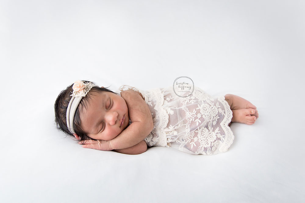 a photo of a posed newborn baby girl