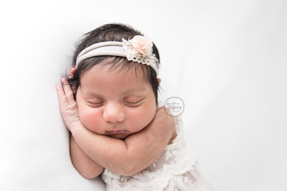 a photo of a posed newborn baby girl