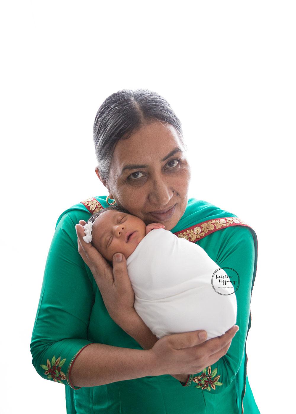 a photo of a grandmother holding her newborn granddaughter