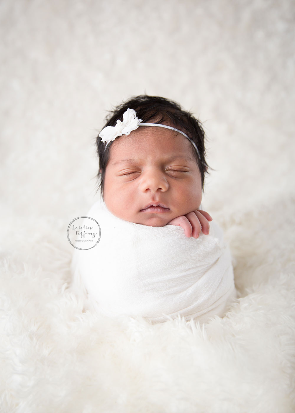 a photo of a posed newborn baby girl