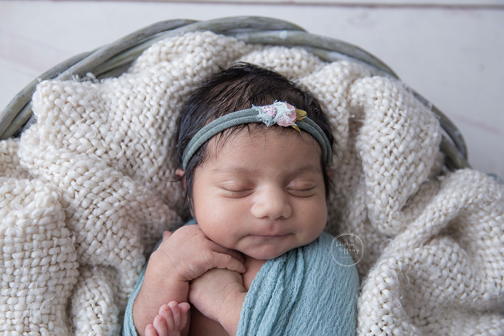 a photo of a posed newborn baby girl