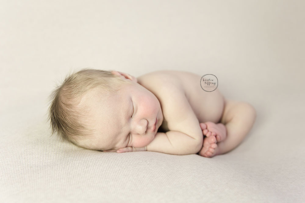 a photo of a posed sleeping baby boy