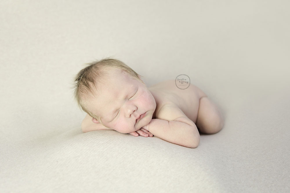 a photo of a posed sleeping baby boy