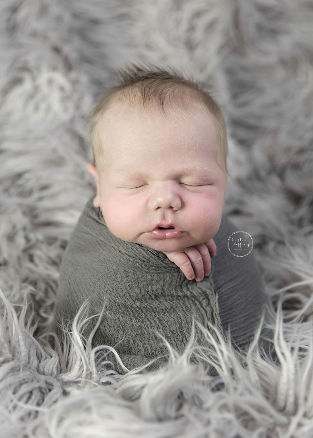 a photo of a posed sleeping baby boy