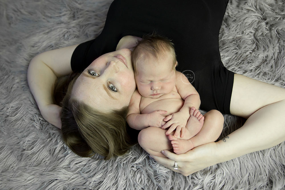 a photo of a posed sleeping baby boy with his mommy