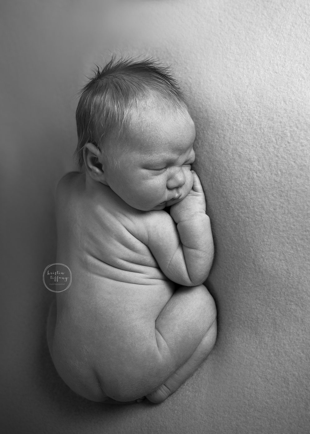 a photo of a posed sleeping baby boy