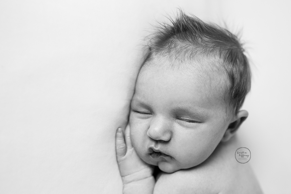 a photo of a newborn baby girl posed sleeping