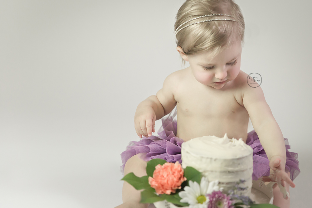 a photo of a baby girl with her smash cake