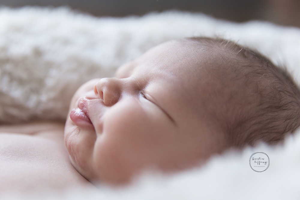 a close up photo of a newborn baby boy and his cute lips