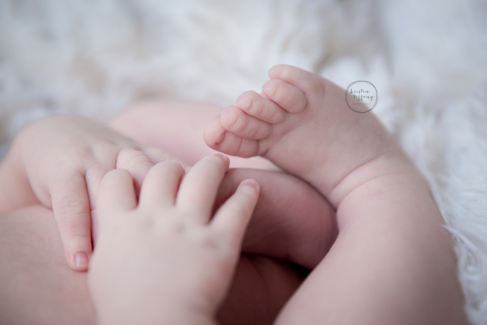 a photo of a newborn baby's feet and hands
