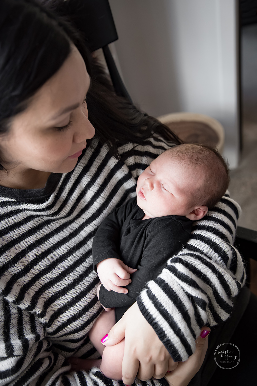 a photo of a mother holding her newborn son