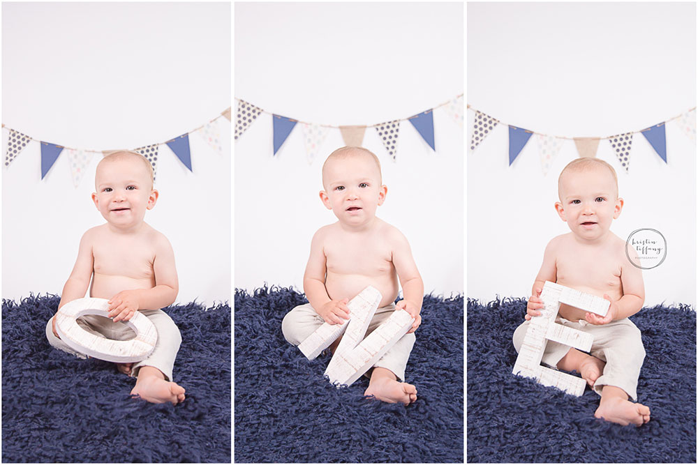 a photo of a baby boy holding one letters