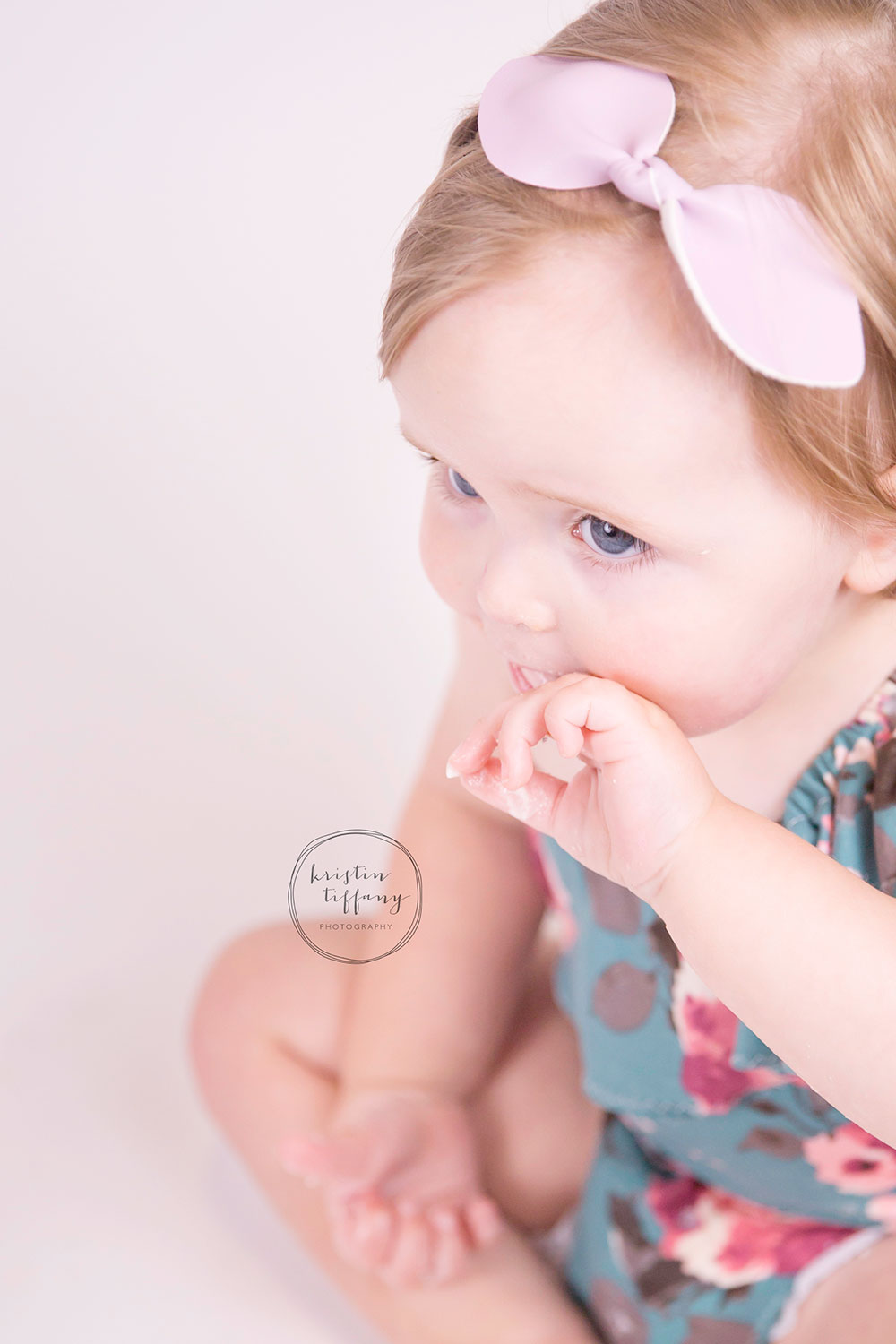 a photo of a baby girl eating a cake smash cake