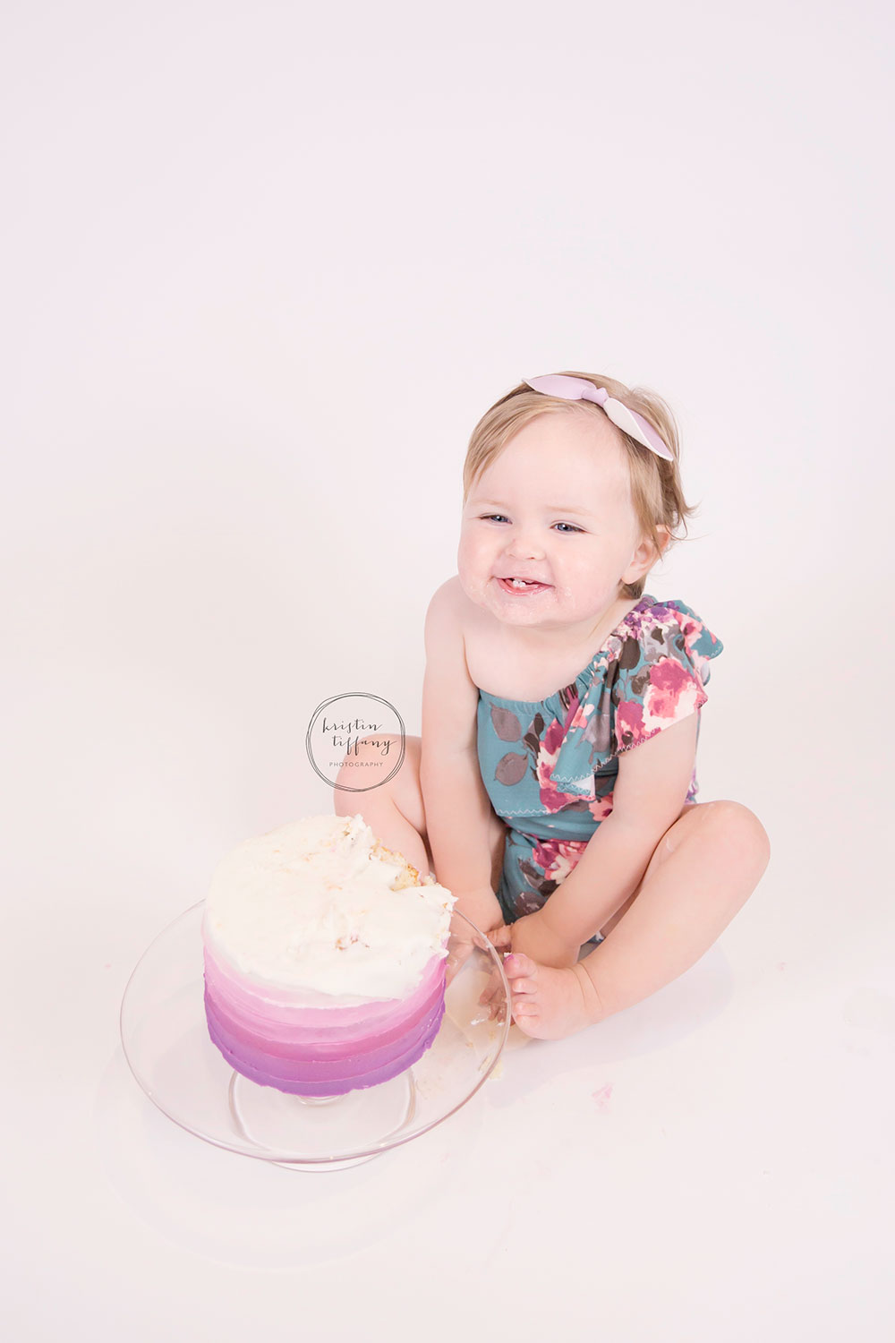 a photo of a baby girl eating a cake smash cake