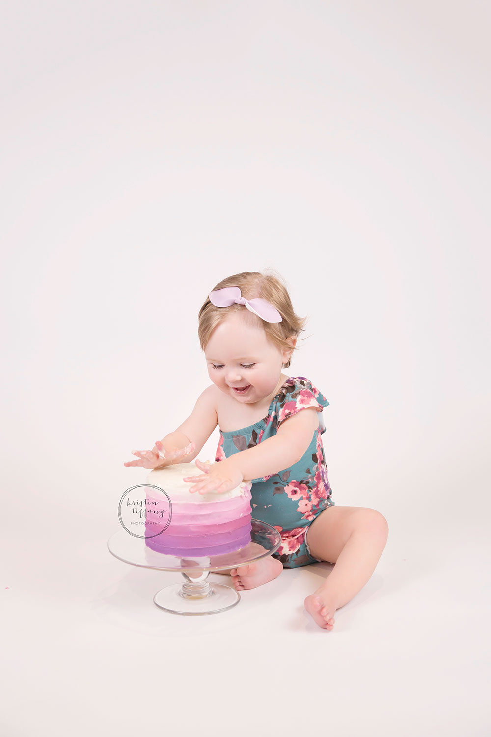 a photo of a baby girl eating a cake smash cake