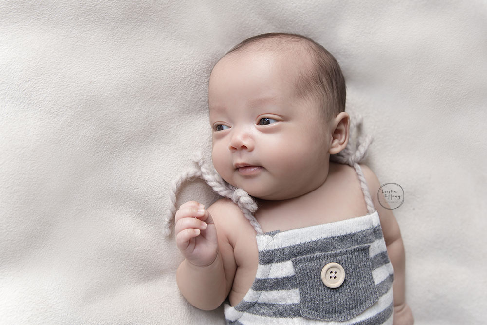a photo of a baby boy wearing a striped romper