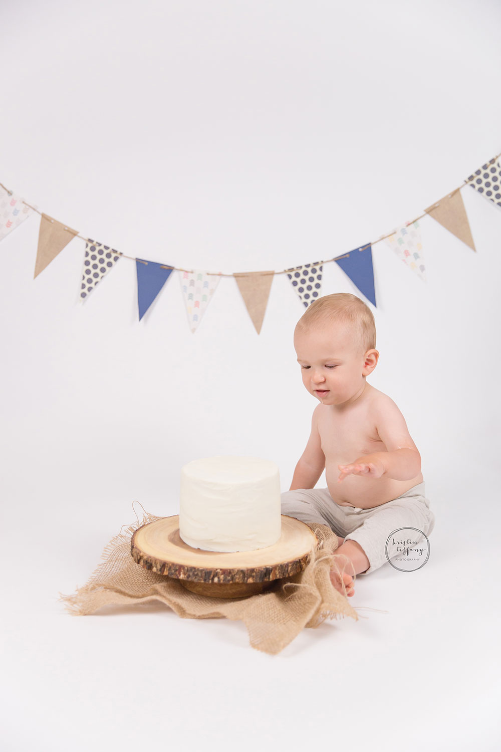 a photo of a baby boy with a cake smash cake