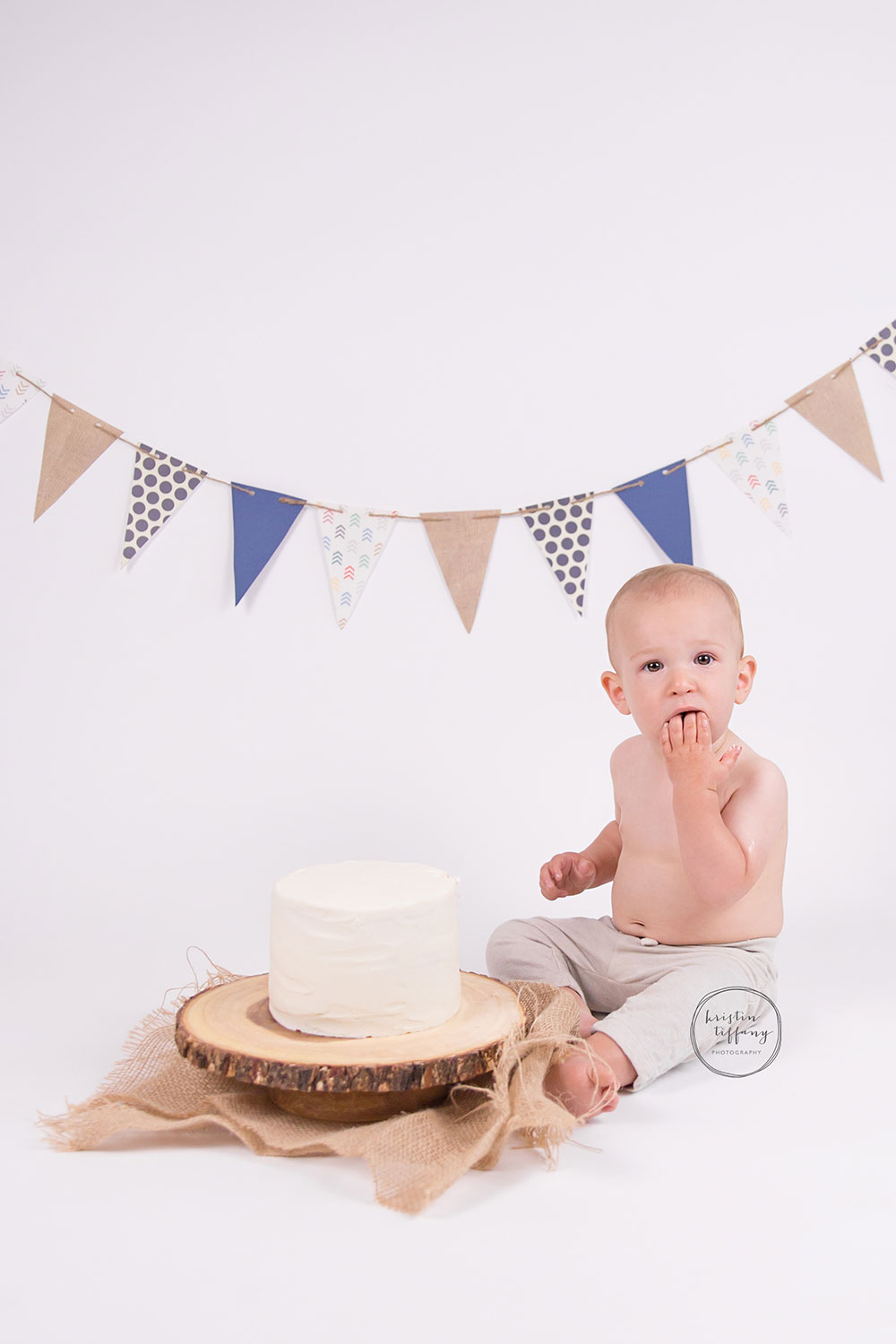 a photo of a baby boy with a cake smash cake