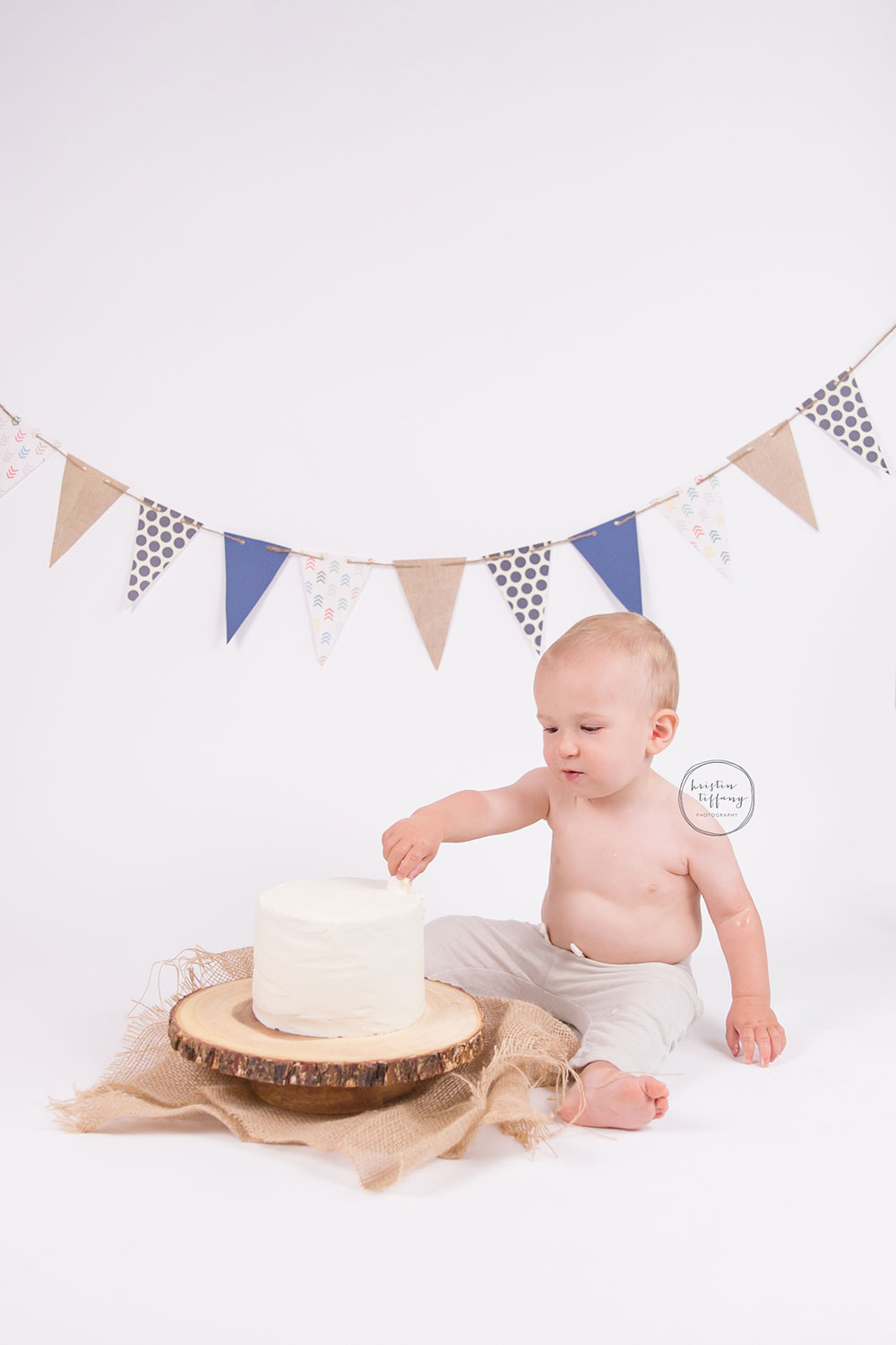 a photo of a baby boy with a cake smash cake