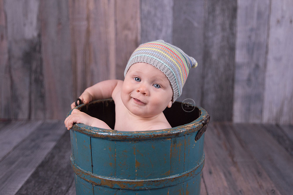 a photo of a baby boy in a bucket